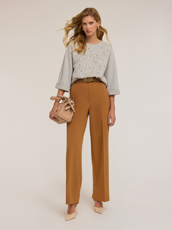 Pantaloni con impunture