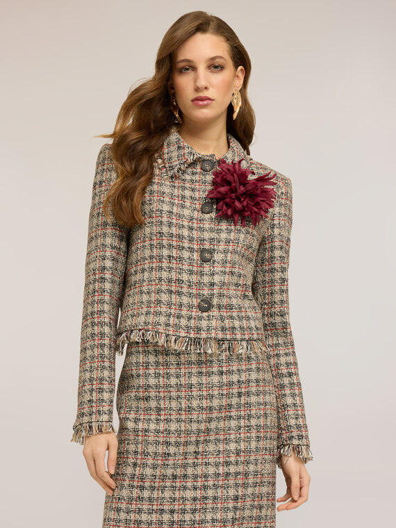 Short boucl&eacute; jacket with fringes and brooch