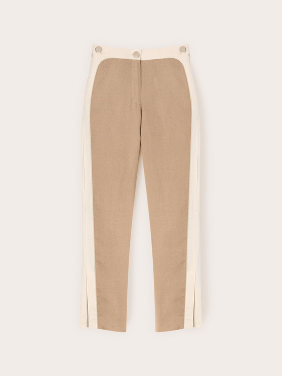 Trousers with piping and slit at the bottom