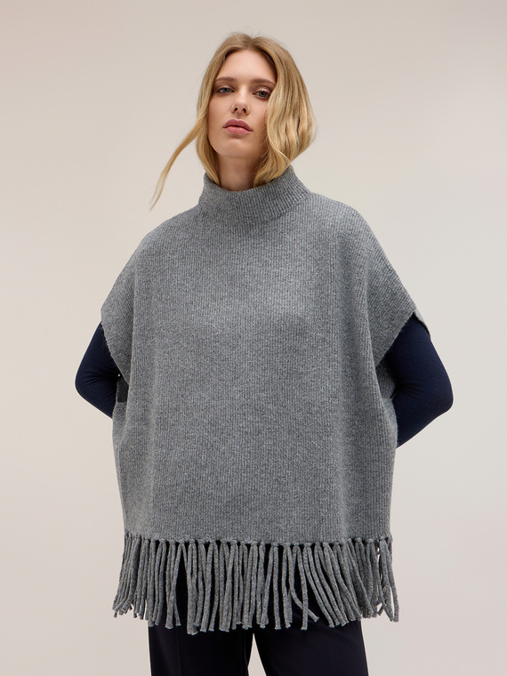 Knit poncho with fringe and high neck
