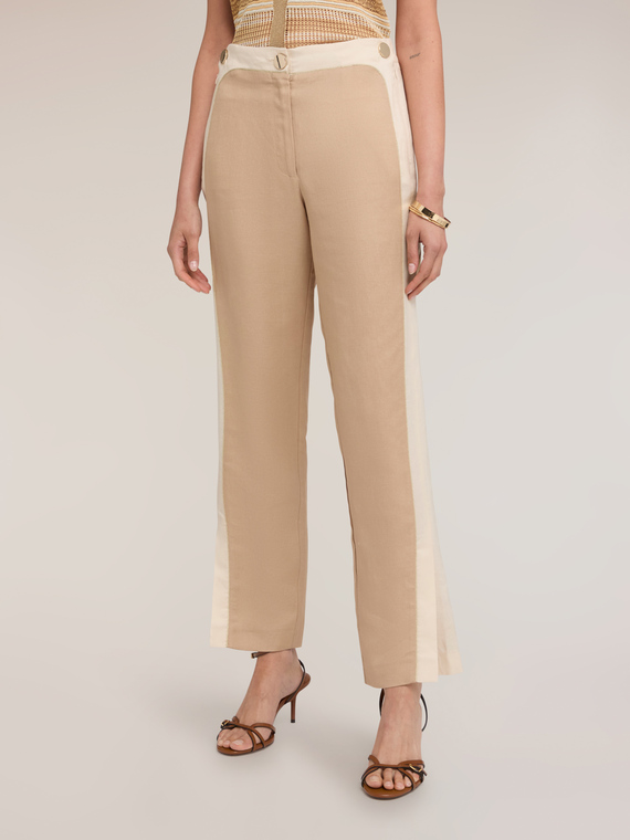 Trousers with piping and slit at the bottom