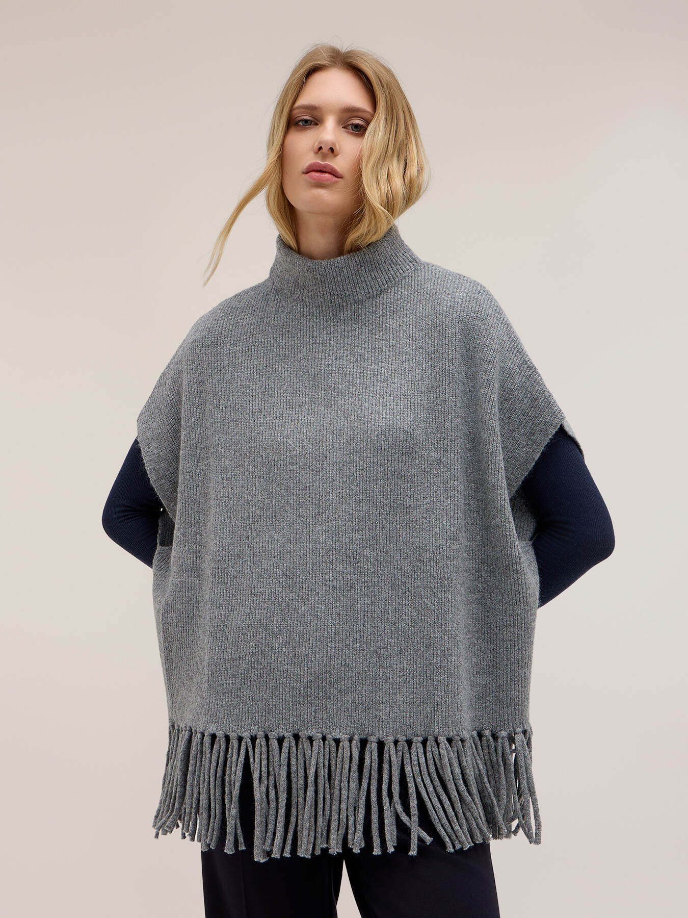 Knit poncho with fringe and high neck image number 0